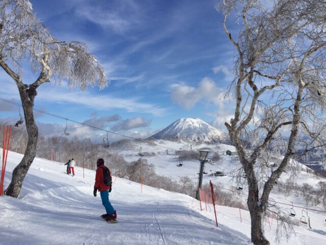 Niseko Annupuri International Ski Resort Winter Season 1 snowboarder ski area yotei background blue sky 2016