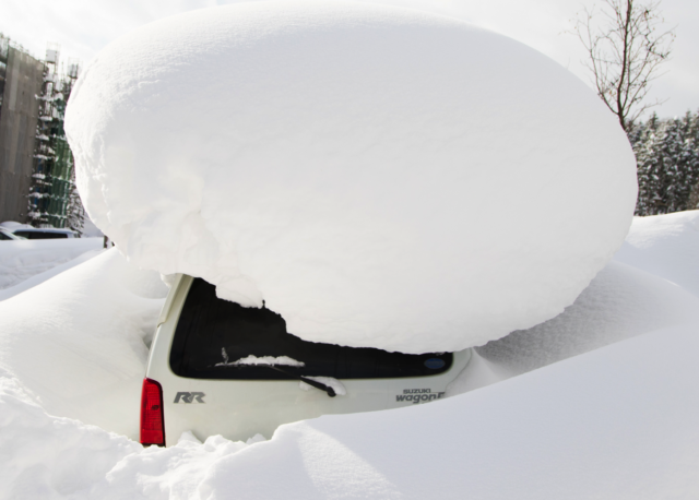 Parked cars can almost get buried by snowfall.